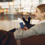 A Business Women sitting at airport - Get the Most Out of a Work Trip