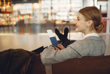 A Business Women sitting at airport - Get the Most Out of a Work Trip